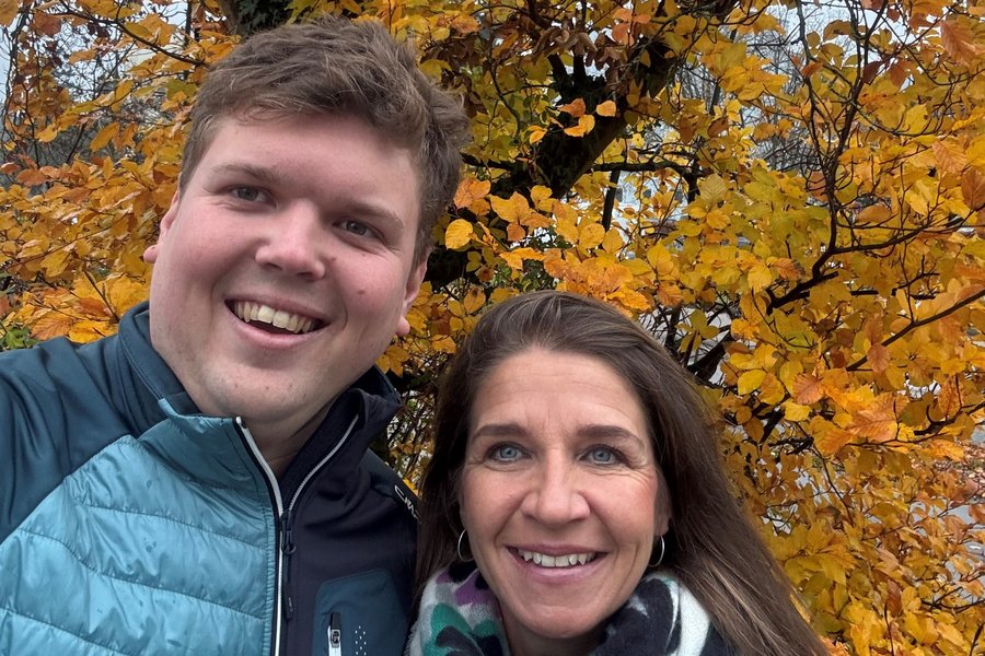 Ein Mann und eine Frau vor einem Laubbaum mit gelben Blättern